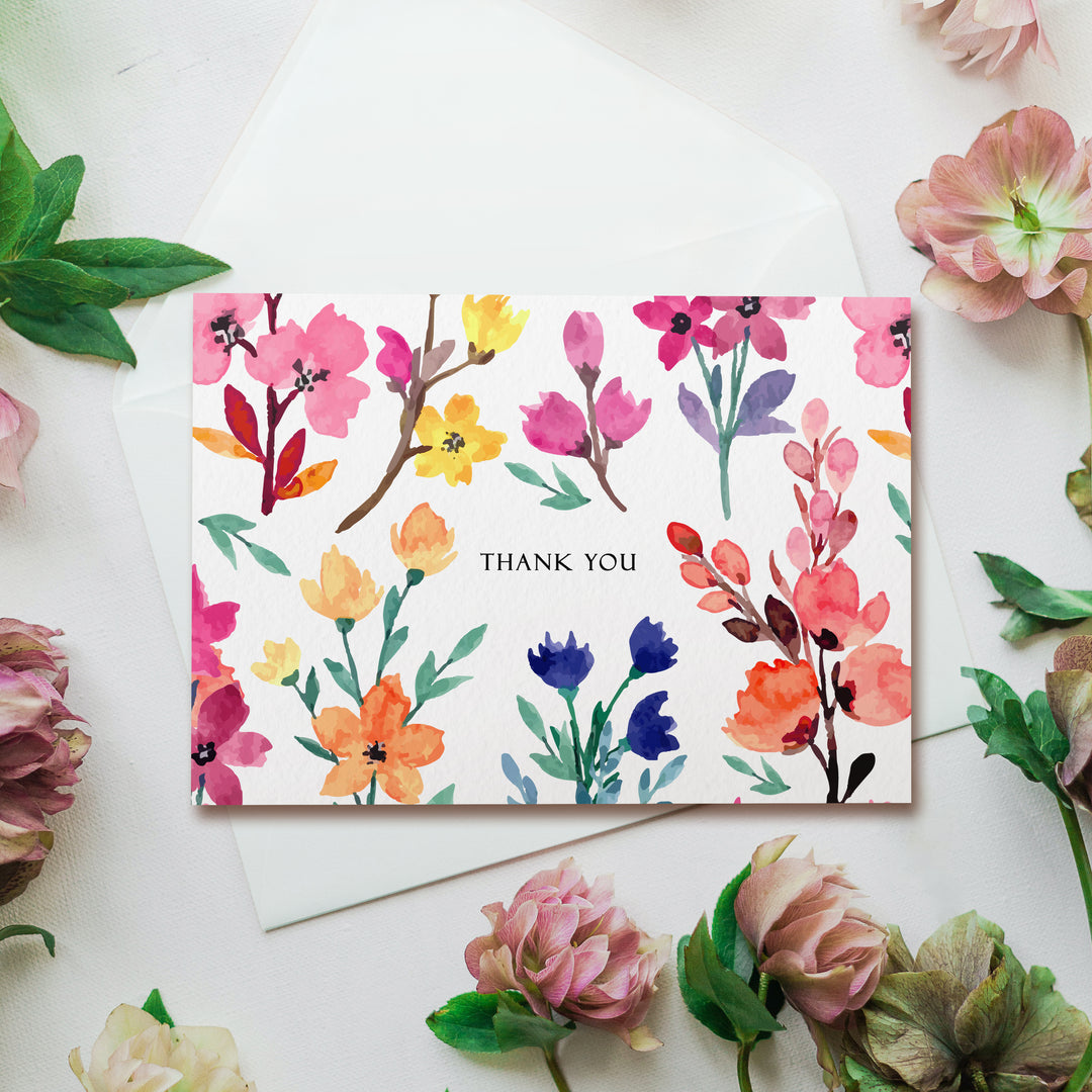 a thank you card surrounded by flowers