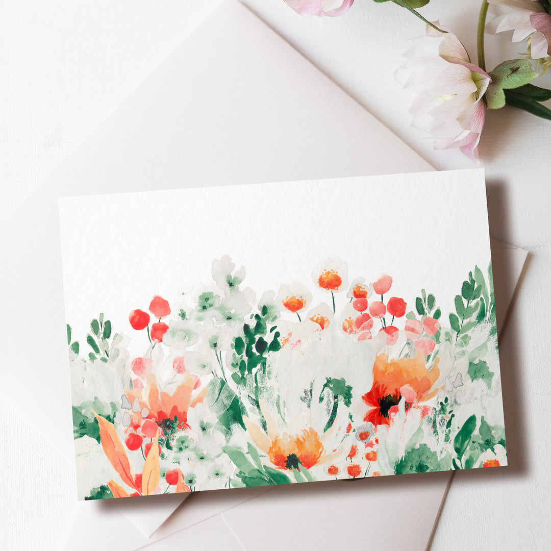 a card with watercolor flowers on it