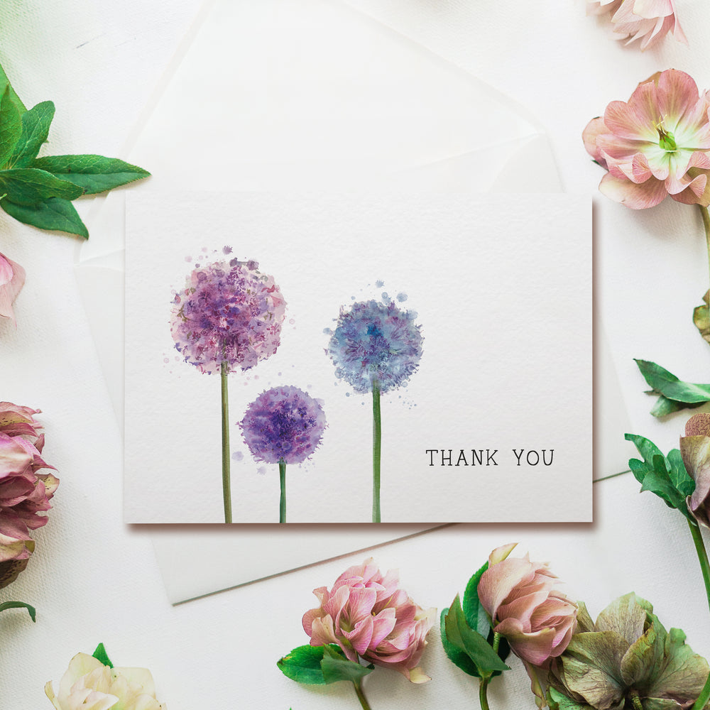 a thank you card with three flowers on it