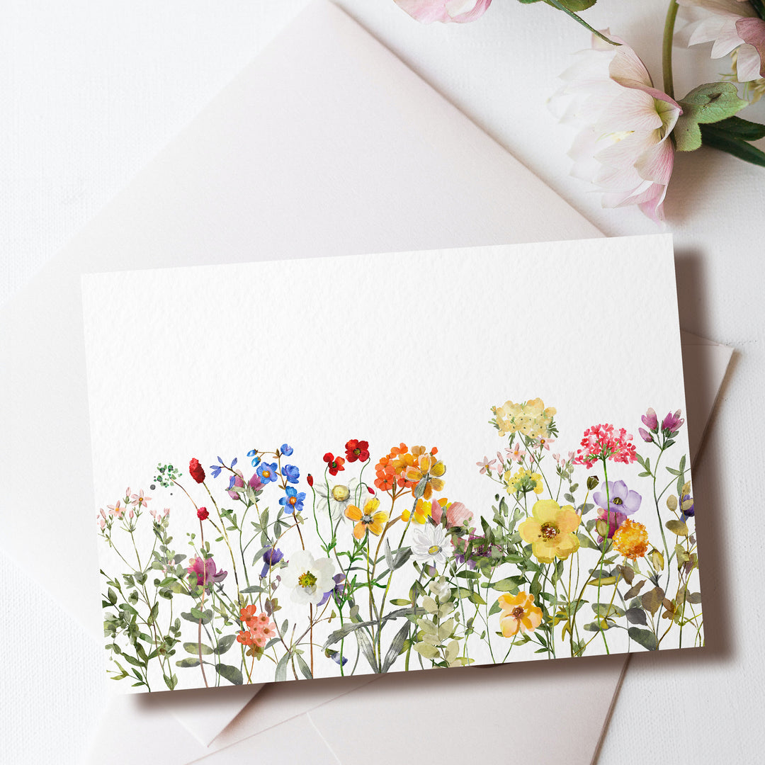 a card with a watercolor painting of flowers on it