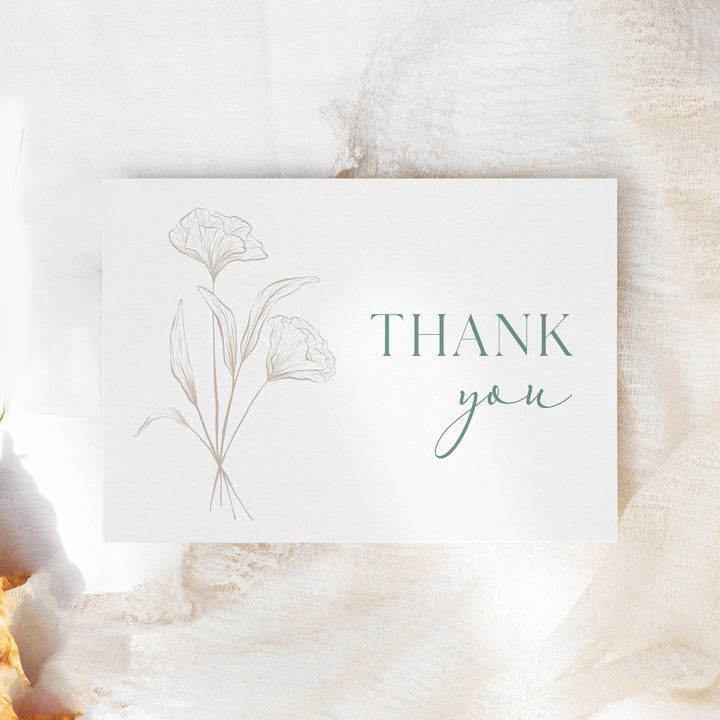 a thank you card sitting on top of a table