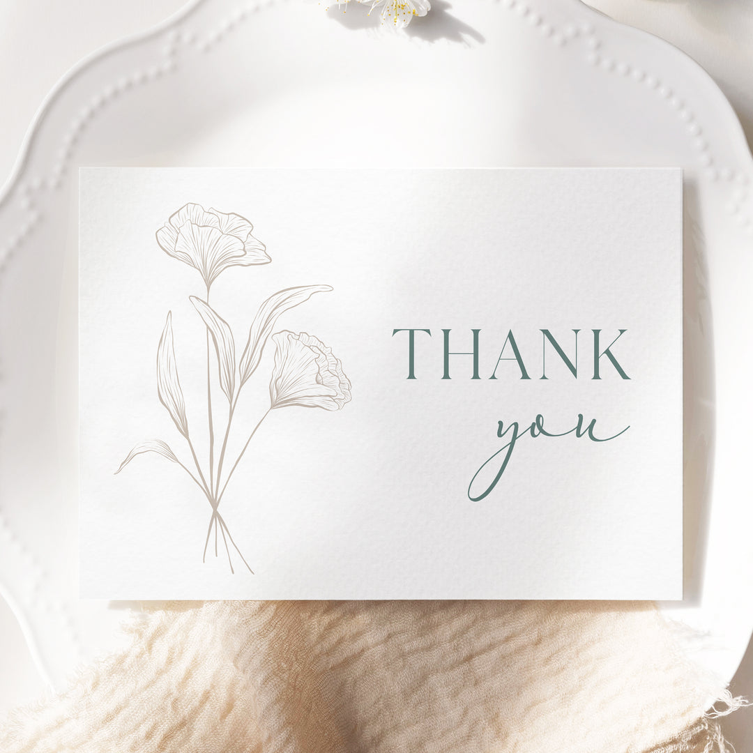 a white plate with a card that says thank you