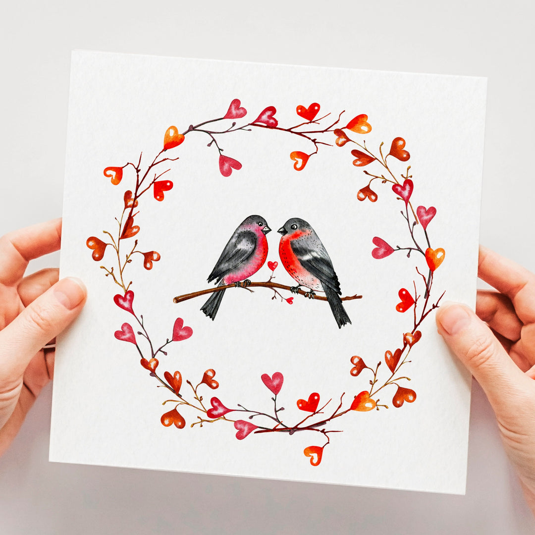 Lovebirds Romantic Card, Watercolour Anniversary Card, Red Heart Valentines Card, Love Card for Couple, Engagement New Relationship Card with two birds on a branch facing each other surrounded by a wreath made out of hearts