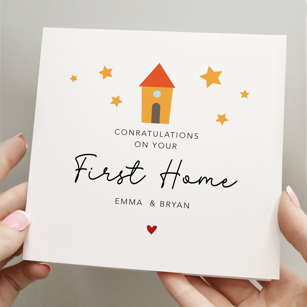 personalised simple and elegant congratulations on your 
first home 
card with handwritten font and red heart and cute yellow house with stars around it