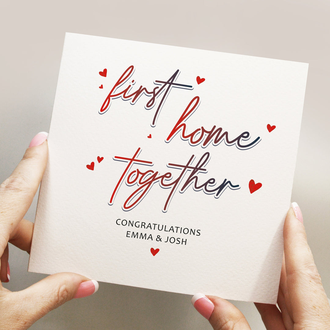 Personalised first home together card for couples with red and purple handwritten text and a lot of floating red hearts moving in together card