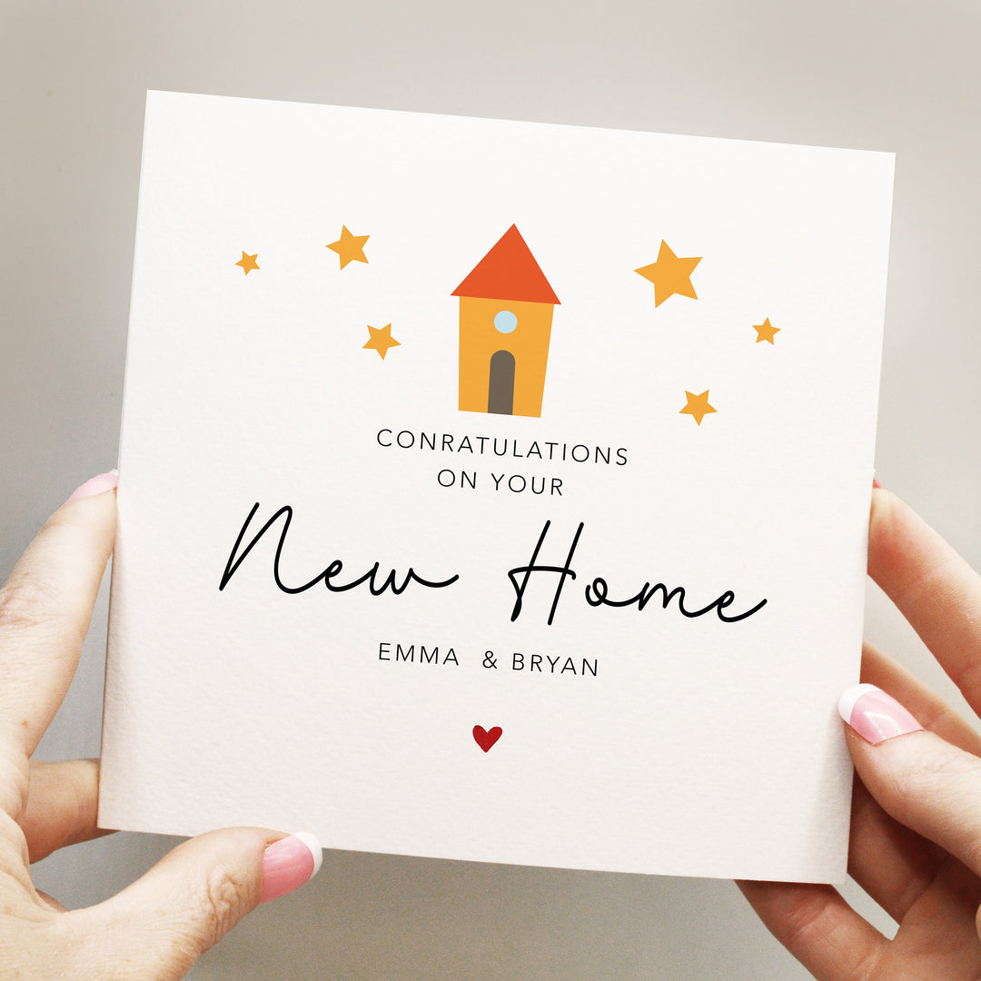 personalised simple and elegant congratulations on your 
new home 
card with handwritten font and red heart and cute yellow house with stars around it