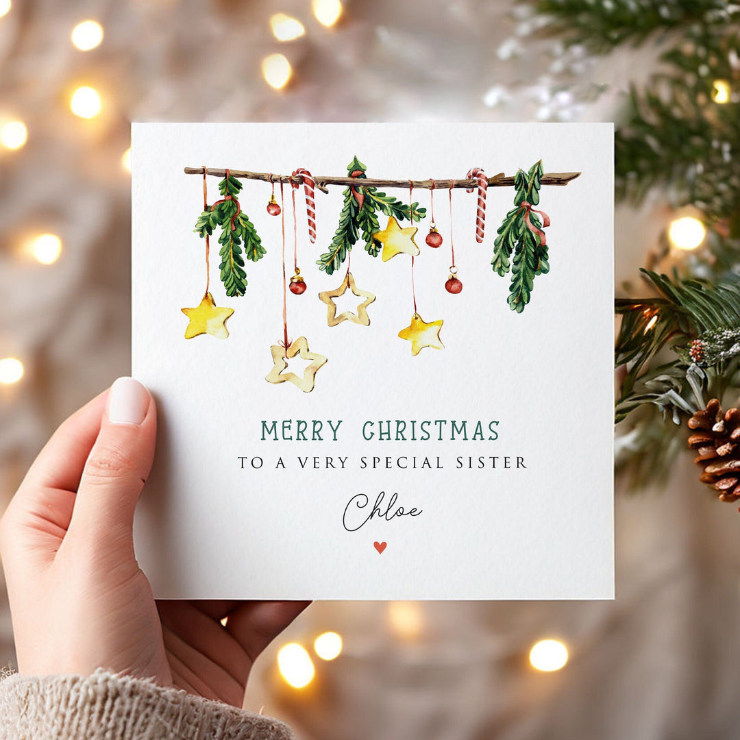 Personalised Christmas Mistletoe Card, Christmas Card for Daughter, Granddaughter, Sister, Auntie, Niece, Mum, Christmas Card With Stars, watercolour mistletoe design with christmas tree branches, baubles, and star shaped ornaments